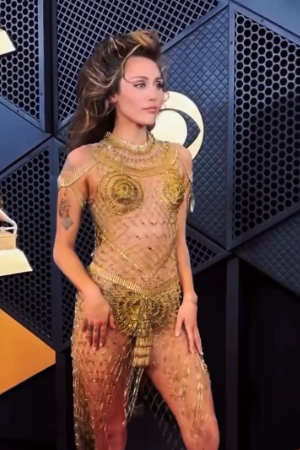 Miley Cyrus wore a daring gold dress and sporting high-hair.